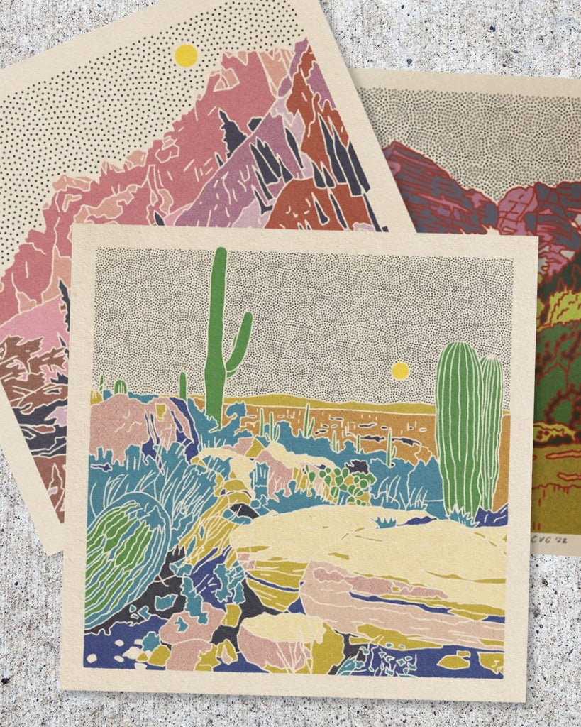 The print is shown stacked on other prints by Colorado artist, Caroline Clark.