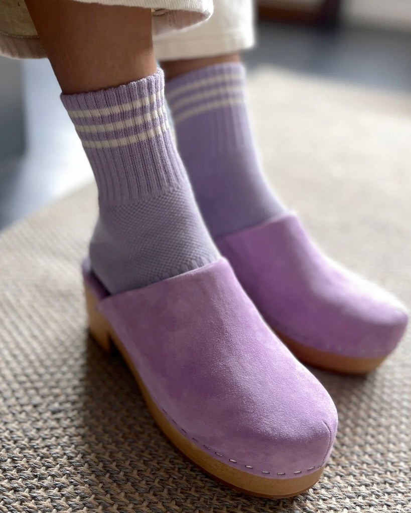 The Iris Girlfriend Socks from Le Bon Shoppe on a model wearing light purple clogs and white pants. 