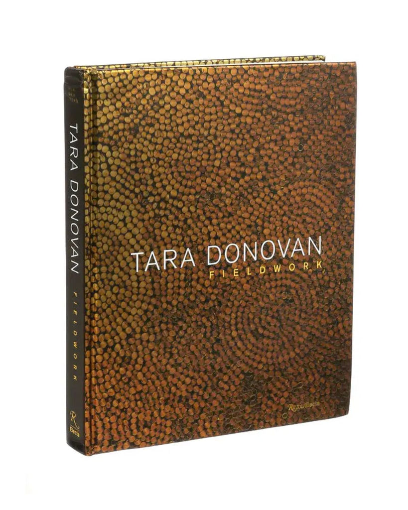Tara Donovan, Fieldwork catalogue has a photo of her gold foil work. The book is metallic gold with white text. 