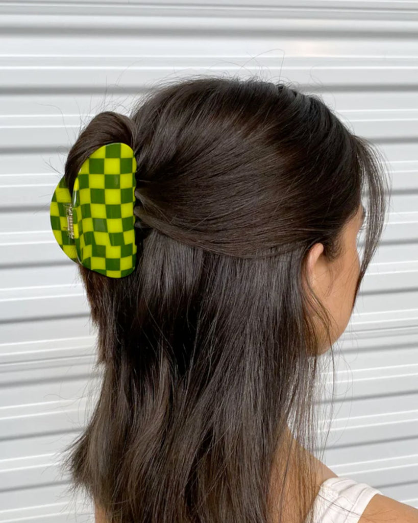 Dill claw clip in lime and olive checkers holds up a half down half up hairdo. 