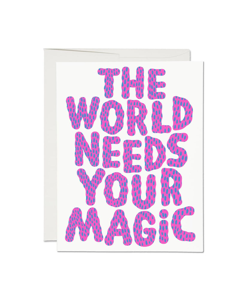 Artist designed greeting card. Card is white with purple and blue speckled bubble letters that read 'The world needs your magic'. 