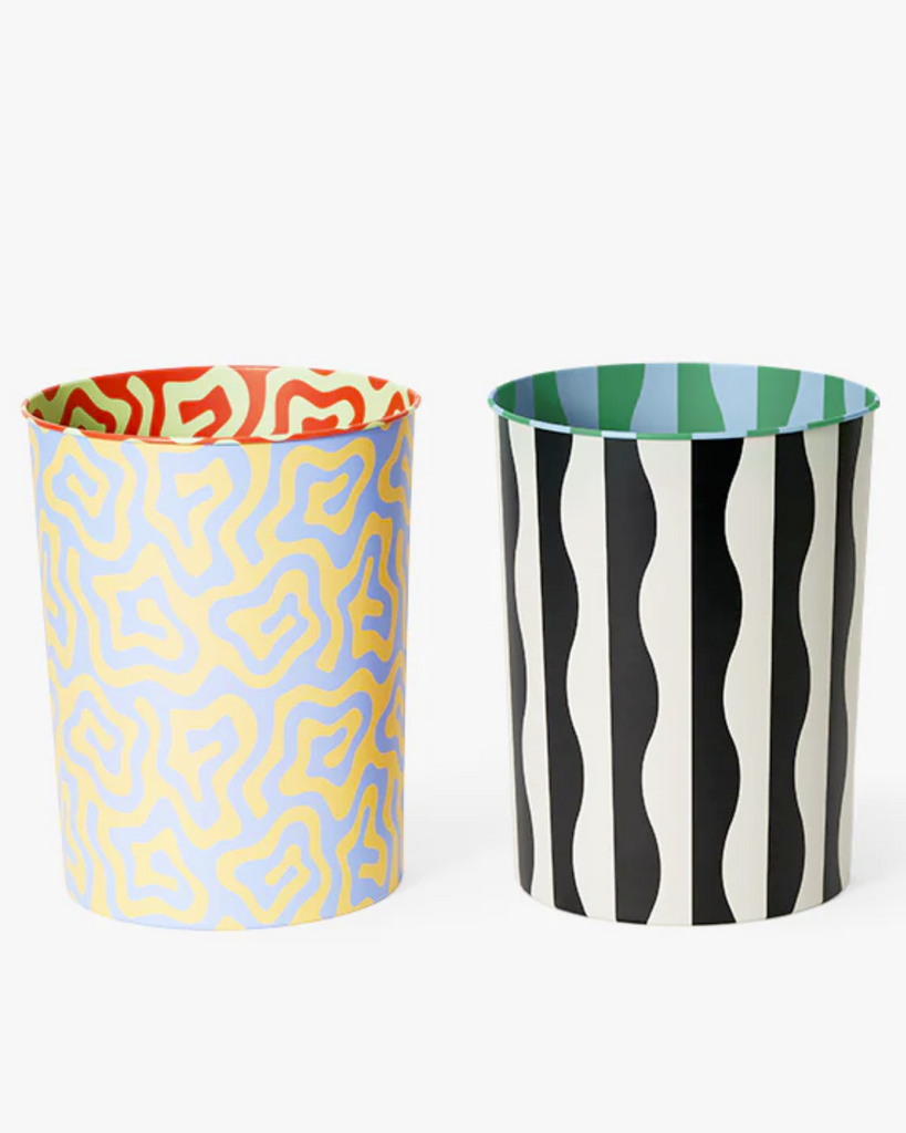 The two variants of the patterned bin with a white backdrop. The blue and yellow spiral bin is on the left and the black and white wavy bin is on the right.  