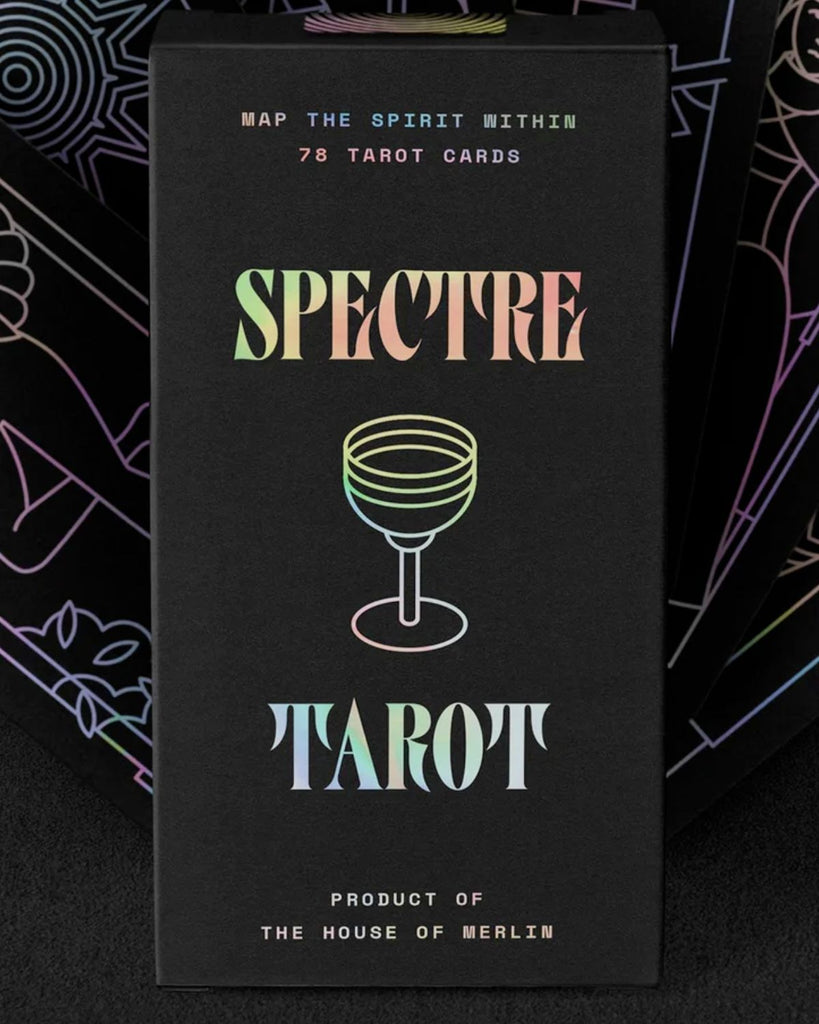 Tarot deck box is black with holographic foiled lettering. In the center is a  holographic line drawing of a wine goblet. On top of the image reads 'Spectre' and below it reads 'Tarot' 