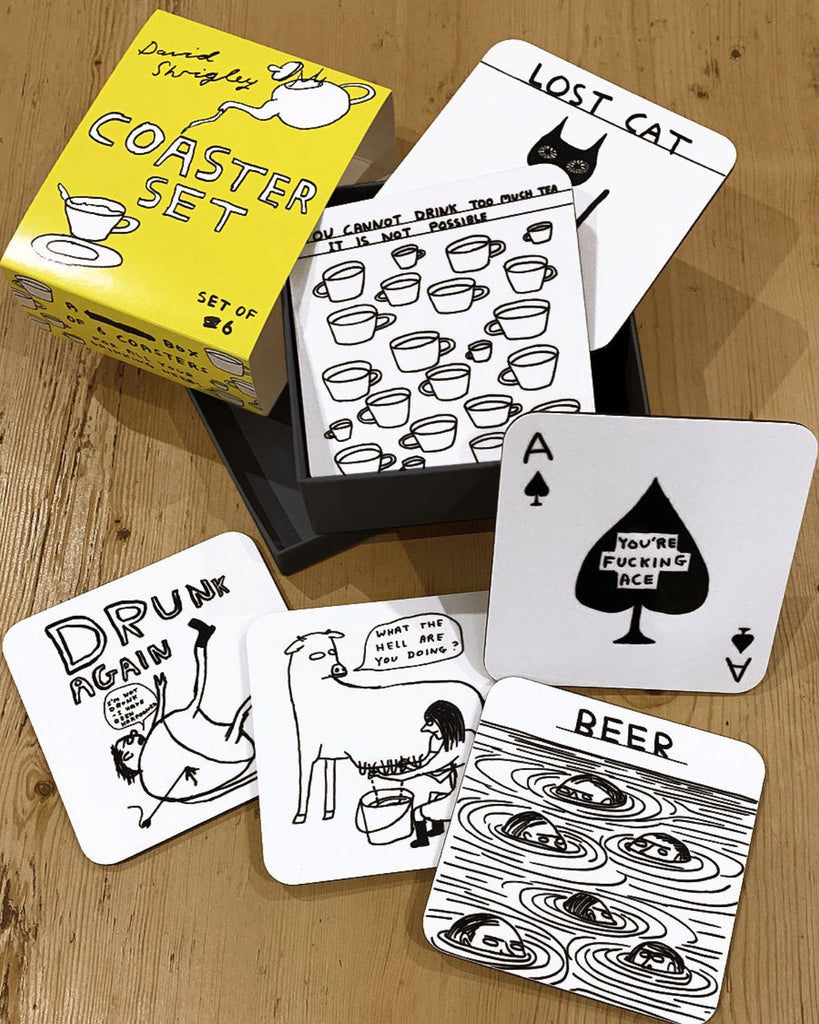 The coasters are displayed outside of the box and each have a different drawing of David Shrigley artwork. 