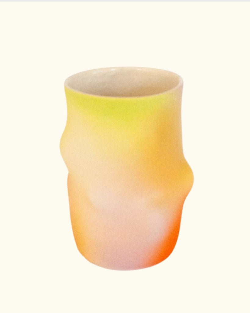 Another view of the ceramic mug to show all the different airbrushed colors. This view shows more yellows, pinks, and oranges.  
