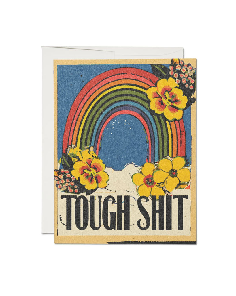 Artist designed greeting card with vintage inspired artwork. A rainbow in the sky on top of white clouds. yellow hawaiian flowers surround it. Bold black text on the bottom reads 'Tough shit'.  