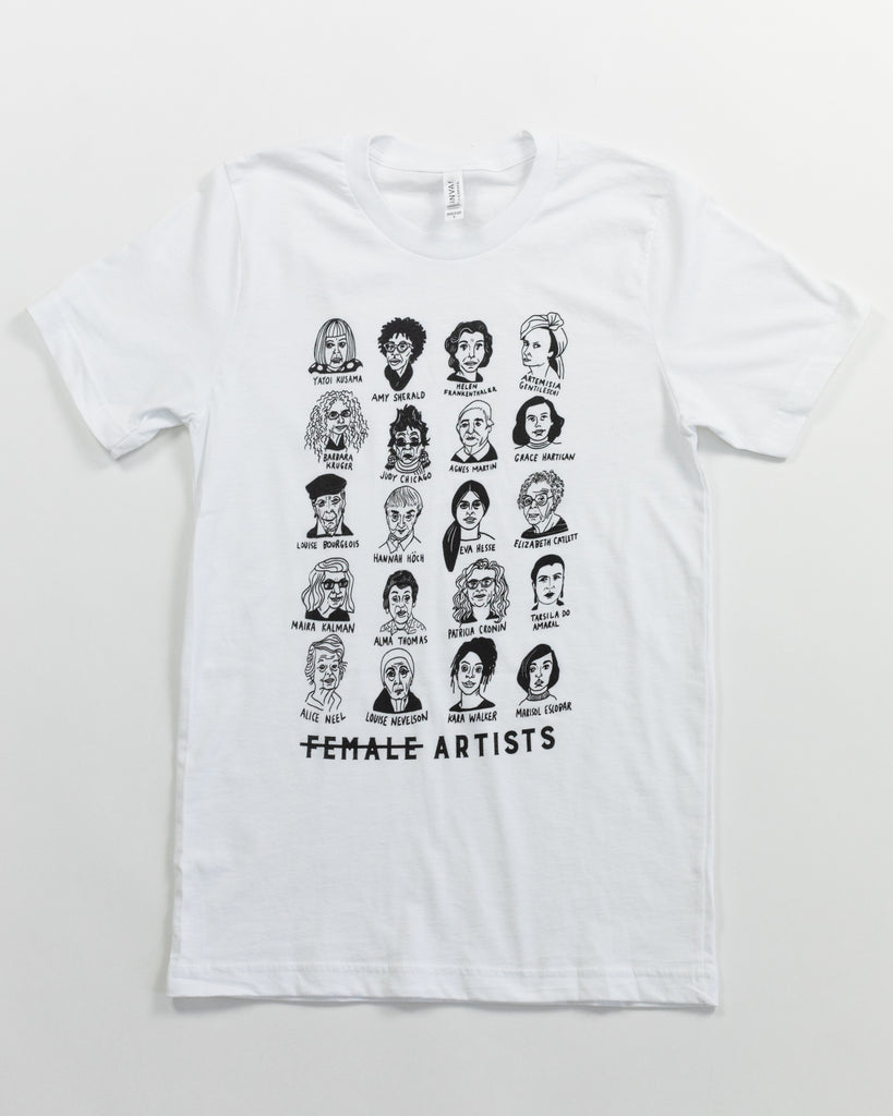 The t-shirt laid out flat against a white surface. The white t-shirt shows illustrations of different female artists in black. Below the rows of faces, text reads 'Female Artists' and the 'Female' is crossed out. 